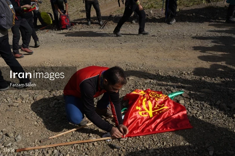 Climbing Tochal Peak with the flag of Imam Hossein (AS)