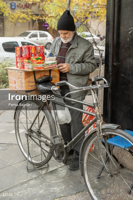 Elderly Biscuit Vendor with Bicycle
