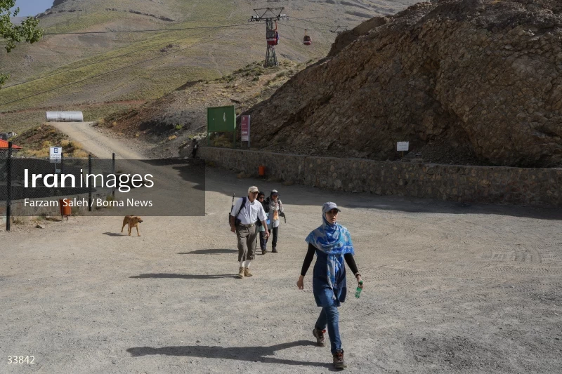 Climbing Tochal Peak with the flag of Imam Hossein (AS)