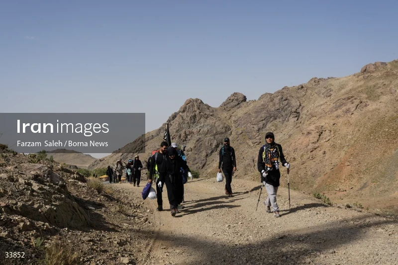 Climbing Tochal Peak with the flag of Imam Hossein (AS)