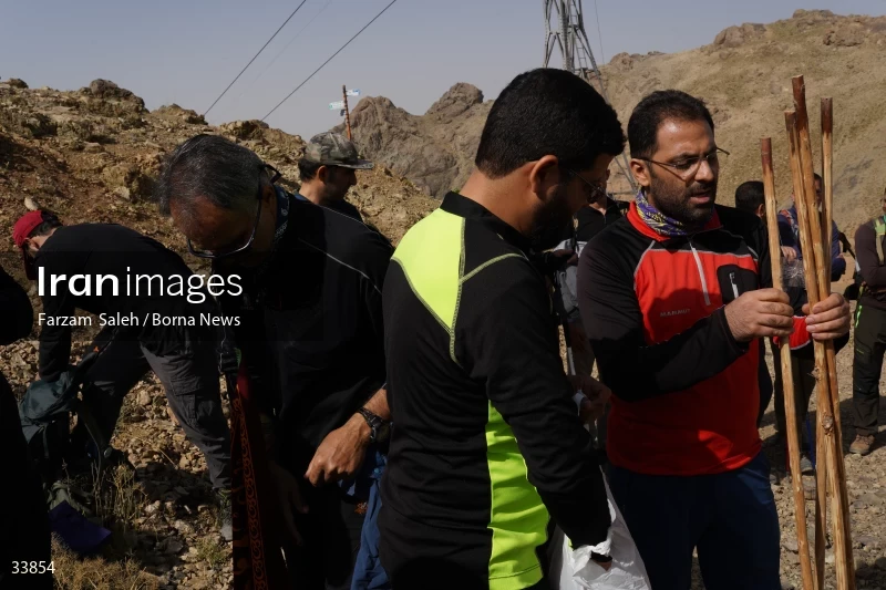 Climbing Tochal Peak with the flag of Imam Hossein (AS)