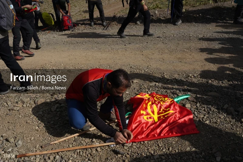 Climbing Tochal Peak with the flag of Imam Hossein (AS)