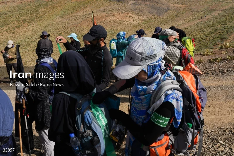 Climbing Tochal Peak with the flag of Imam Hossein (AS)