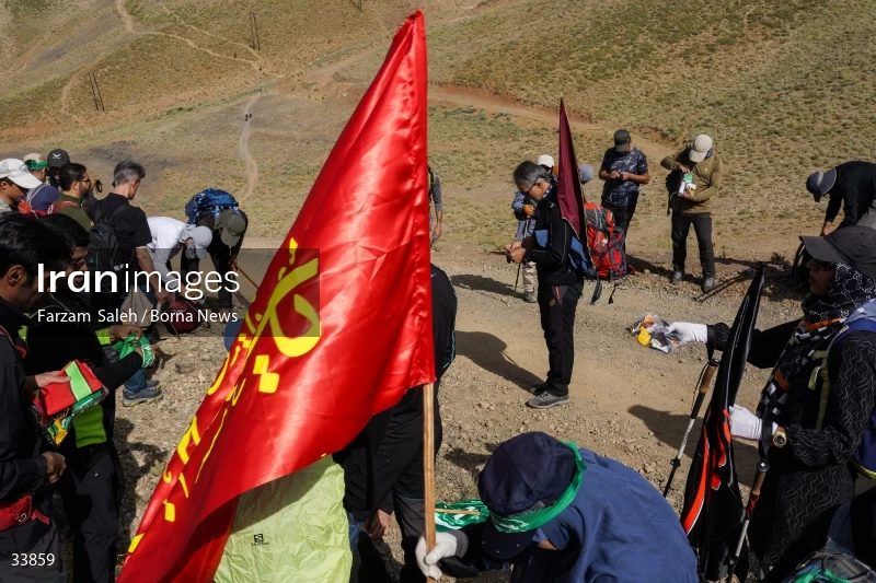 Climbing Tochal Peak with the flag of Imam Hossein (AS)