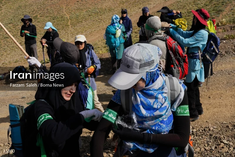Climbing Tochal Peak with the flag of Imam Hossein (AS)