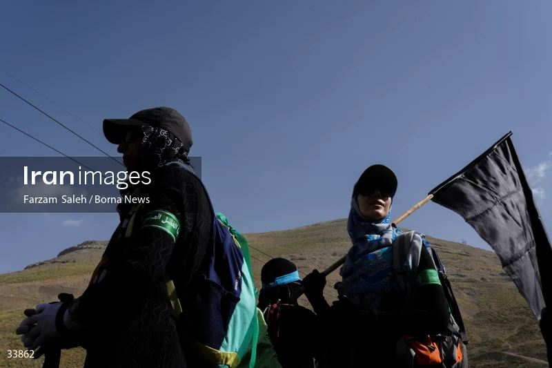 Climbing Tochal Peak with the flag of Imam Hossein (AS)