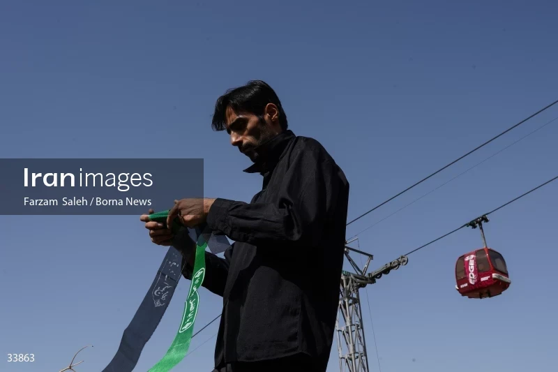 Climbing Tochal Peak with the flag of Imam Hossein (AS)