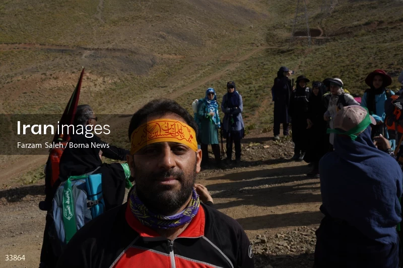 Climbing Tochal Peak with the flag of Imam Hossein (AS)