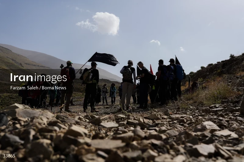 Climbing Tochal Peak with the flag of Imam Hossein (AS)