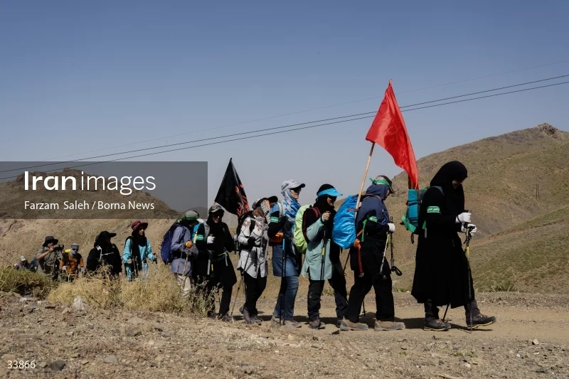 Climbing Tochal Peak with the flag of Imam Hossein (AS)