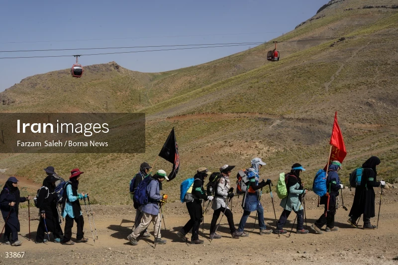 Climbing Tochal Peak with the flag of Imam Hossein (AS)