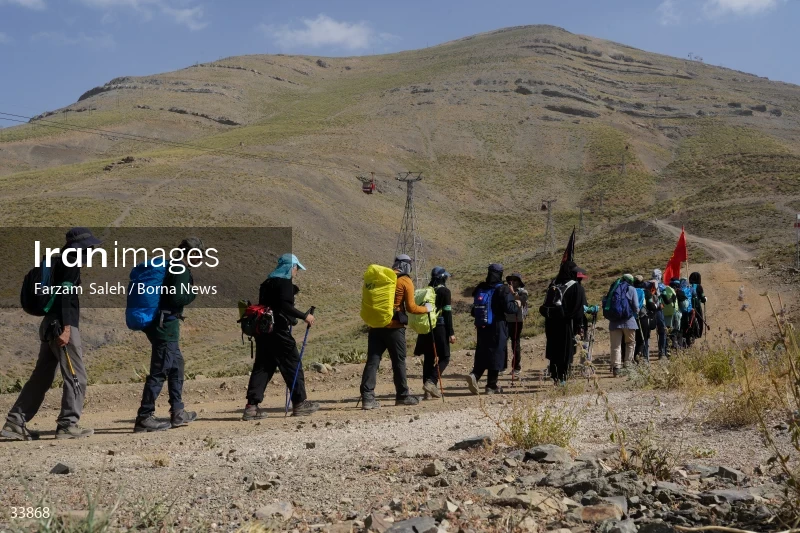 Climbing Tochal Peak with the flag of Imam Hossein (AS)