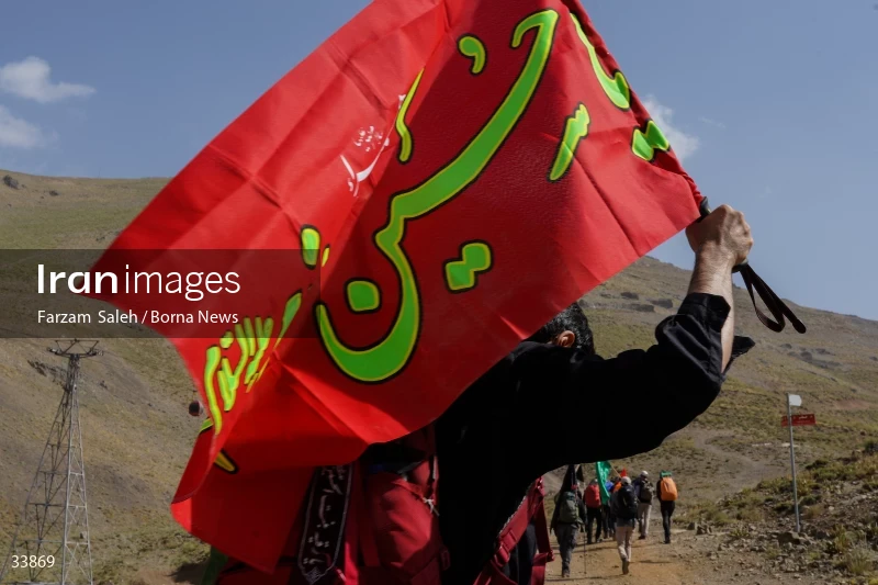 Climbing Tochal Peak with the flag of Imam Hossein (AS)